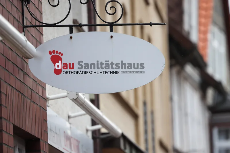 Nasenschild mit dem Logo von Dau Sanitätshaus an der Langen Straße 37